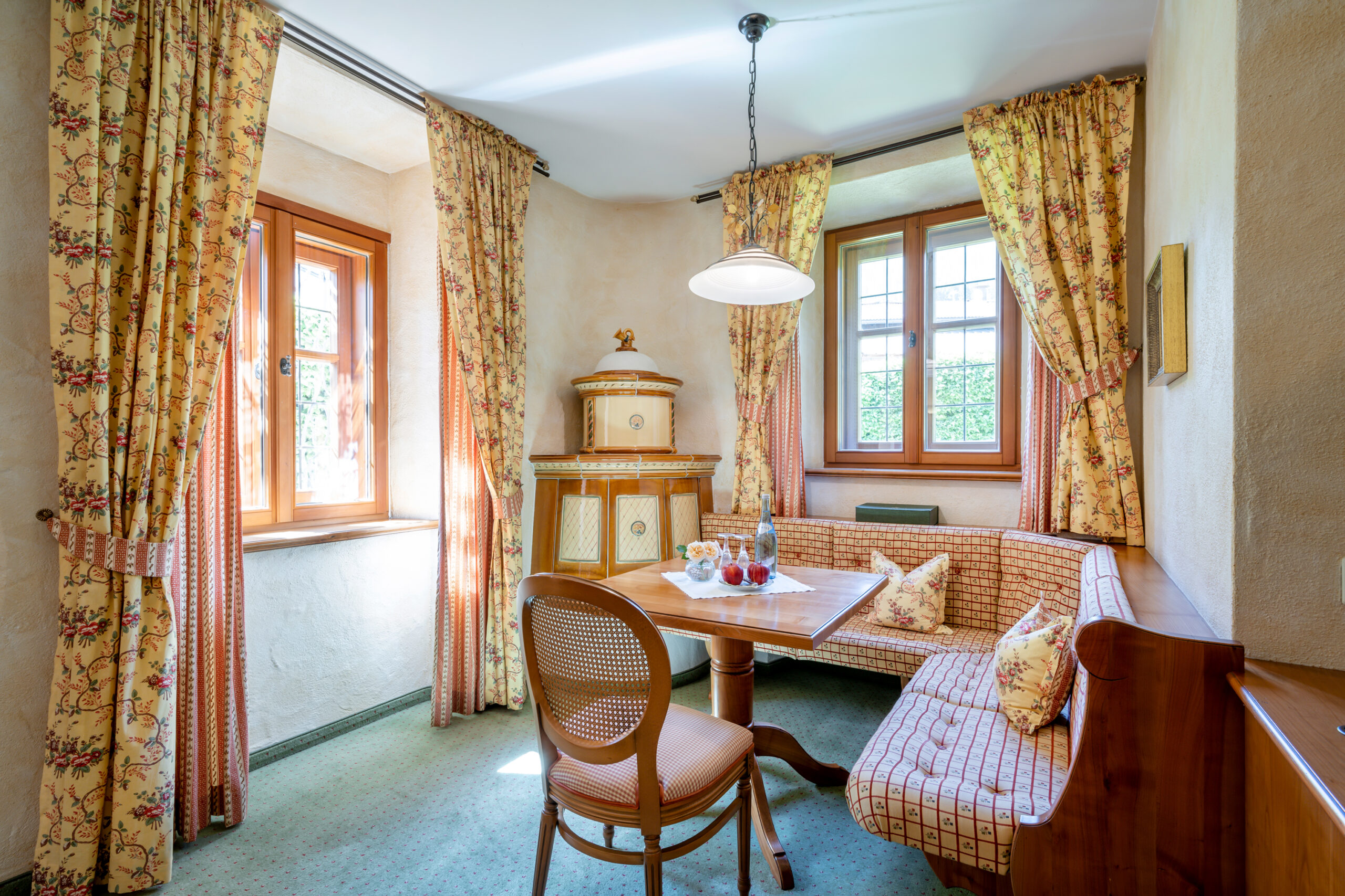 Gemütliche Stube mit Tisch, Eckbank und Kachelofen